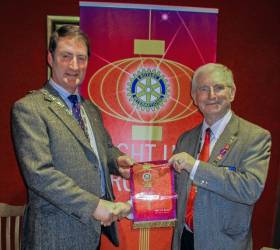 President of Rotary Club of Penicuik, Dave Anderson receiving a pennant from the District Governor Alistair Marquis.